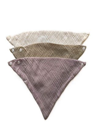 Three triangular fabric panels in beige, brown, and purple on a white background