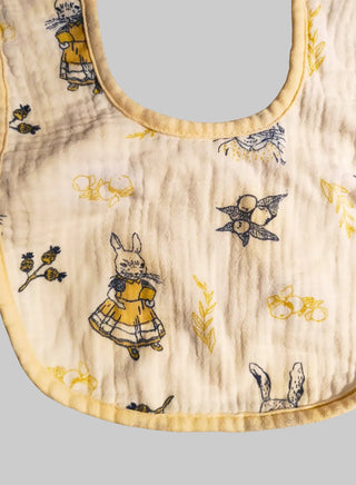 Baby bib with vintage-style illustrations of a rabbit and other elements on a white background