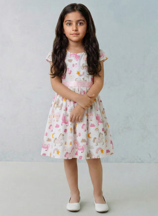 Young girl wearing a patterned dress against a plain background
