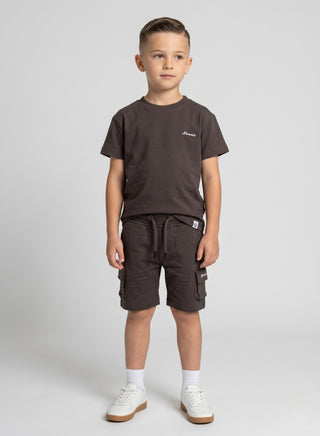 Boy wearing a beige short-sleeve T-shirt with matching cargo shorts featuring side pockets and a drawstring waist.