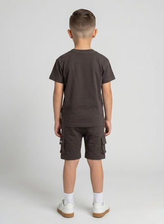 Boy wearing a beige short-sleeve T-shirt with matching cargo shorts featuring side pockets and a drawstring waist.