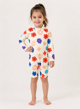 Smiling girl wearing cream long-sleeve one-piece swimsuit with colorful flower print