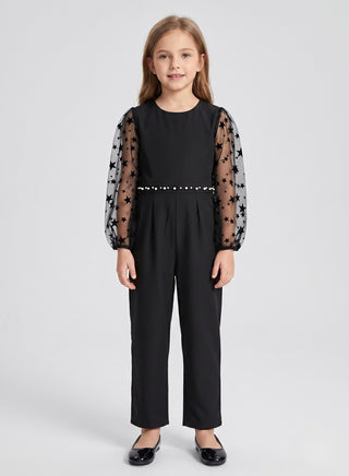Girl wearing a black party jumpsuit with star-print mesh puff sleeves and pearl waist detail, perfect for birthdays, parties, festive celebrations, and special occasions.