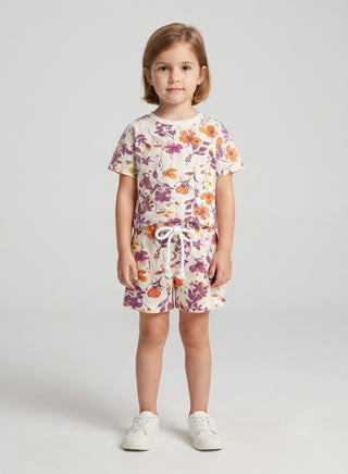 Girl wearing beige floral print cotton t-shirt and matching drawstring shorts set, front view — summer casual outfit for ages 1 to 12 years