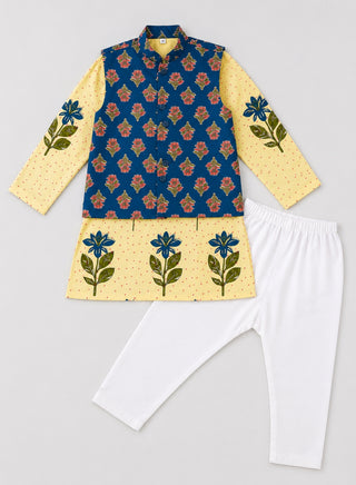 Flat lay of boys cream floral printed kurta, blue floral Nehru jacket and white pajama ethnic wear set for kids aged 1–10 years.