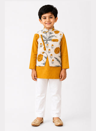 Boy wearing a mustard yellow kurta with floral printed Nehru jacket and white pajama ethnic wear set for kids aged 1–10 years.