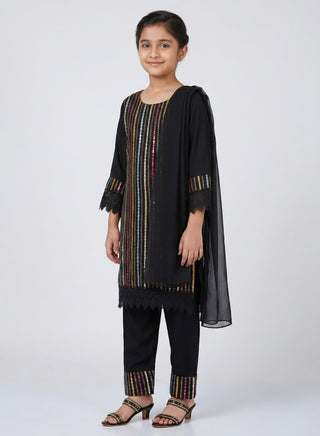 Girl wearing a black embroidered kurta with matching pants and chiffon dupatta ethnic wear set for kids aged 4–12 years.