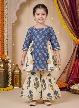 Girl wearing a blue floral printed cotton kurta with matching cream floral sharara pants ethnic wear set for kids aged 1–10 years.
