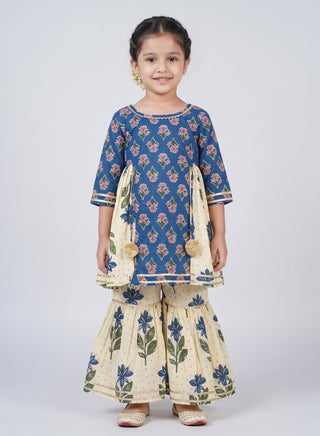 Girl wearing a blue floral printed cotton kurta with matching cream floral sharara pants ethnic wear set for kids aged 1–10 years.