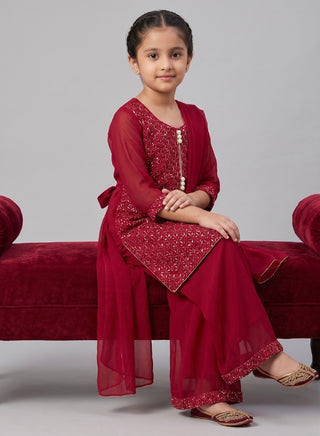Girl wearing a embroidered 3/4 sleeve kurta with a matching plazzaao salwar and chiffon dupatta ethnic wear set for kids aged 4–12 years.