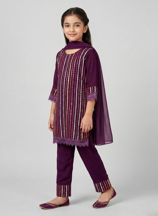 Girl wearing a purple embroidered kurta with matching pants and chiffon dupatta ethnic wear set for kids aged 4–12 years.