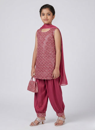 Girl wearing a rose pink embroidered sleeveless kurta with matching Patiala salwar, chiffon dupatta, and coordinating handbag ethnic wear set for kids aged 4–12 years.