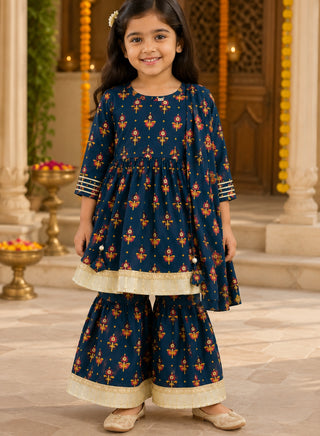 Girl wearing a teal blue floral printed kurta and sharara ethnic set with gold lace detailing for ages 1–10 years.