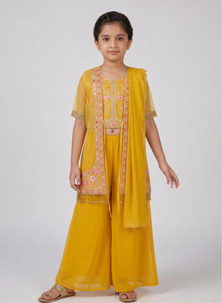 Girl wearing a yellow embroidered sleeveless top with matching embroidered jacket, palazzo pants, and chiffon dupatta ethnic wear set for kids aged 4–12 years.